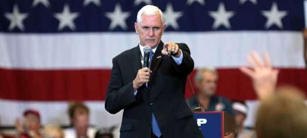 Mike Pence speaking with supporters at a campaign rally for Donald Trump.