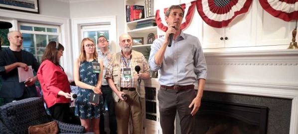 Beto O'Rourke speaking with supporters at a house party in Ames, Iowa.