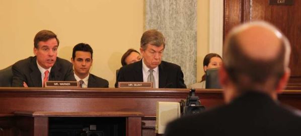  Roy Blunt and Mark Warner, question witnesses in a Surface Transportation hearing, 2013.